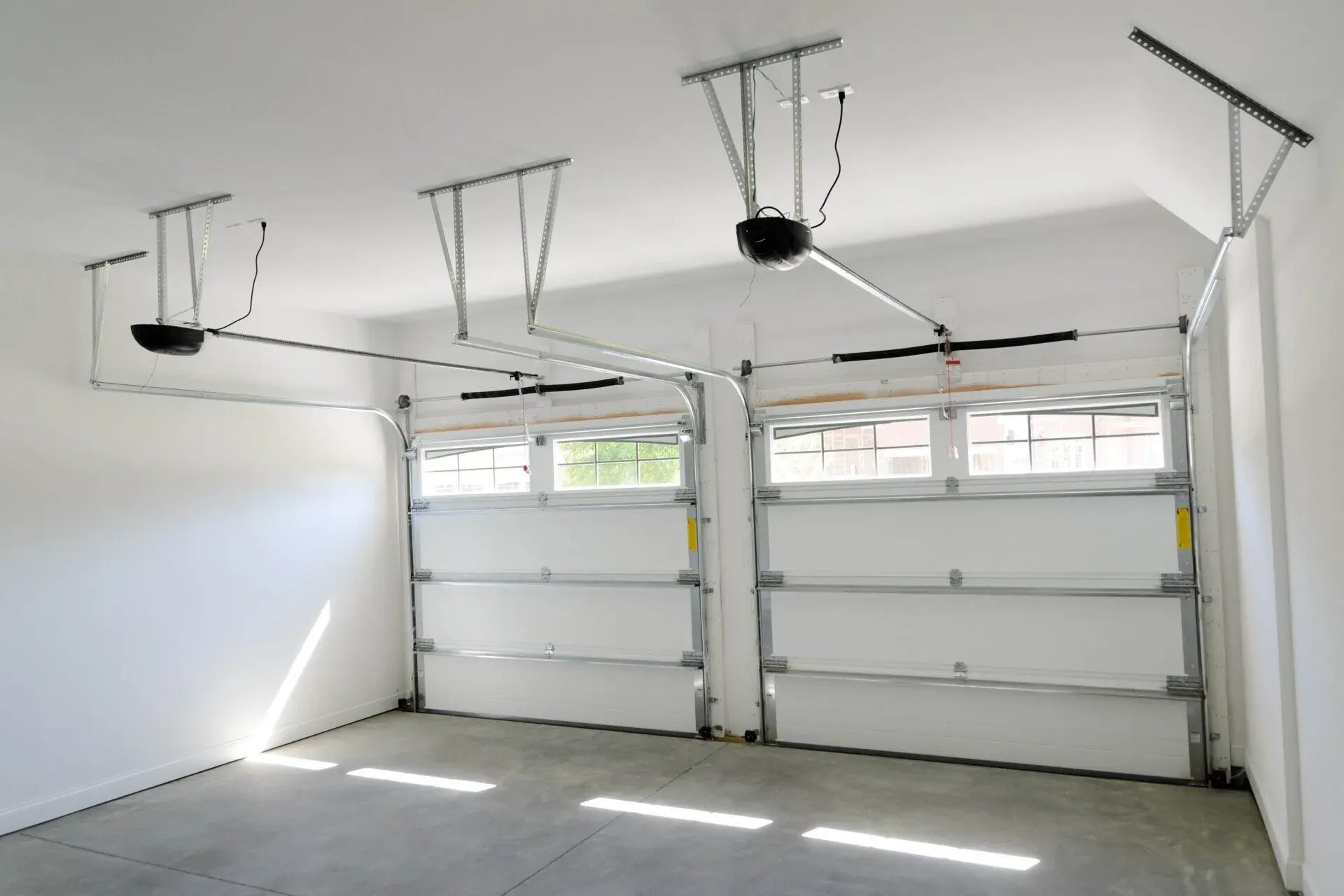 Commercial garage doors with high-lift track in a clean interior