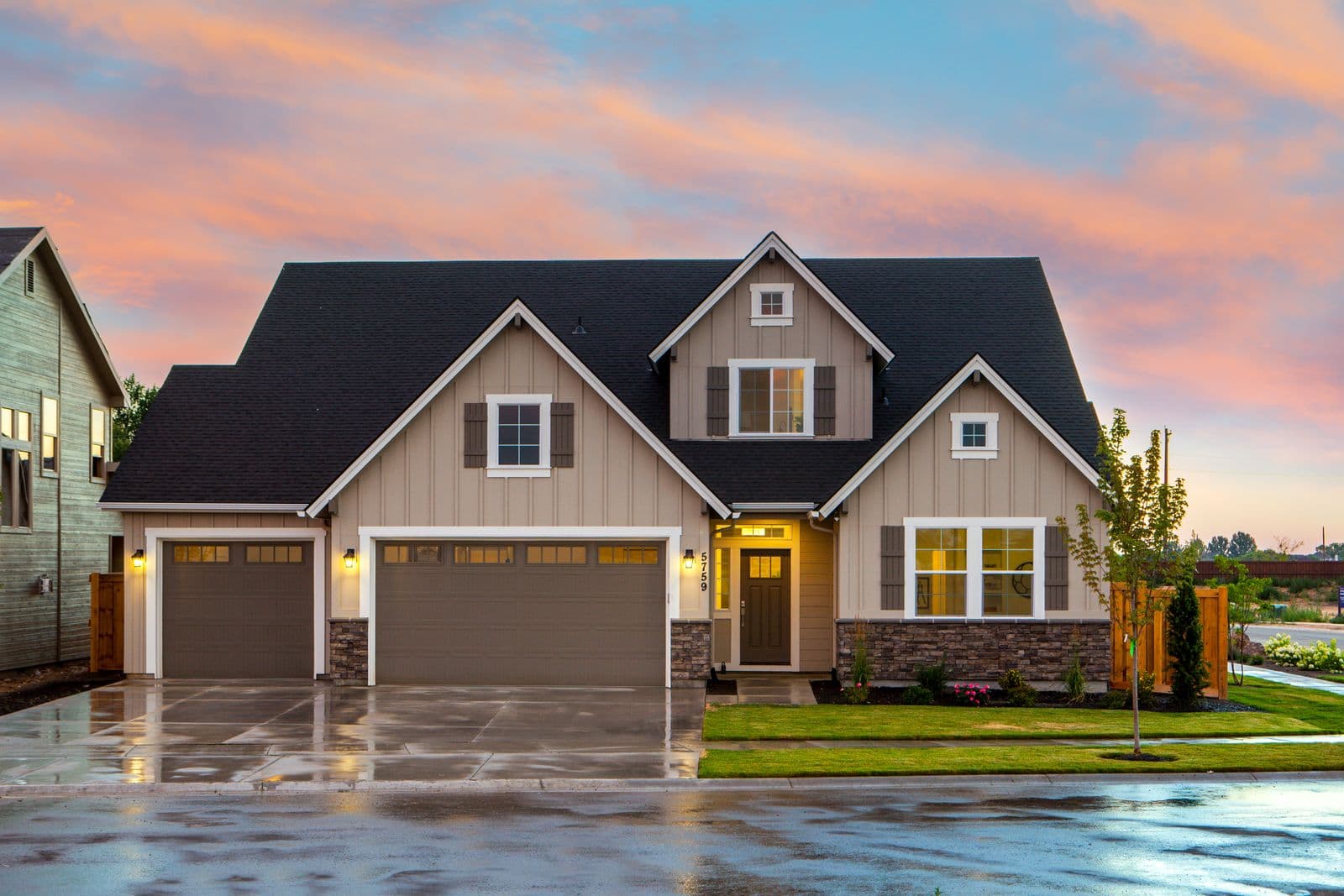 New garage doors on a craftsman home at sunset