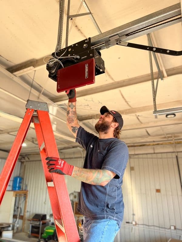 B&B technician servicing a ceiling-mounted garage door opener